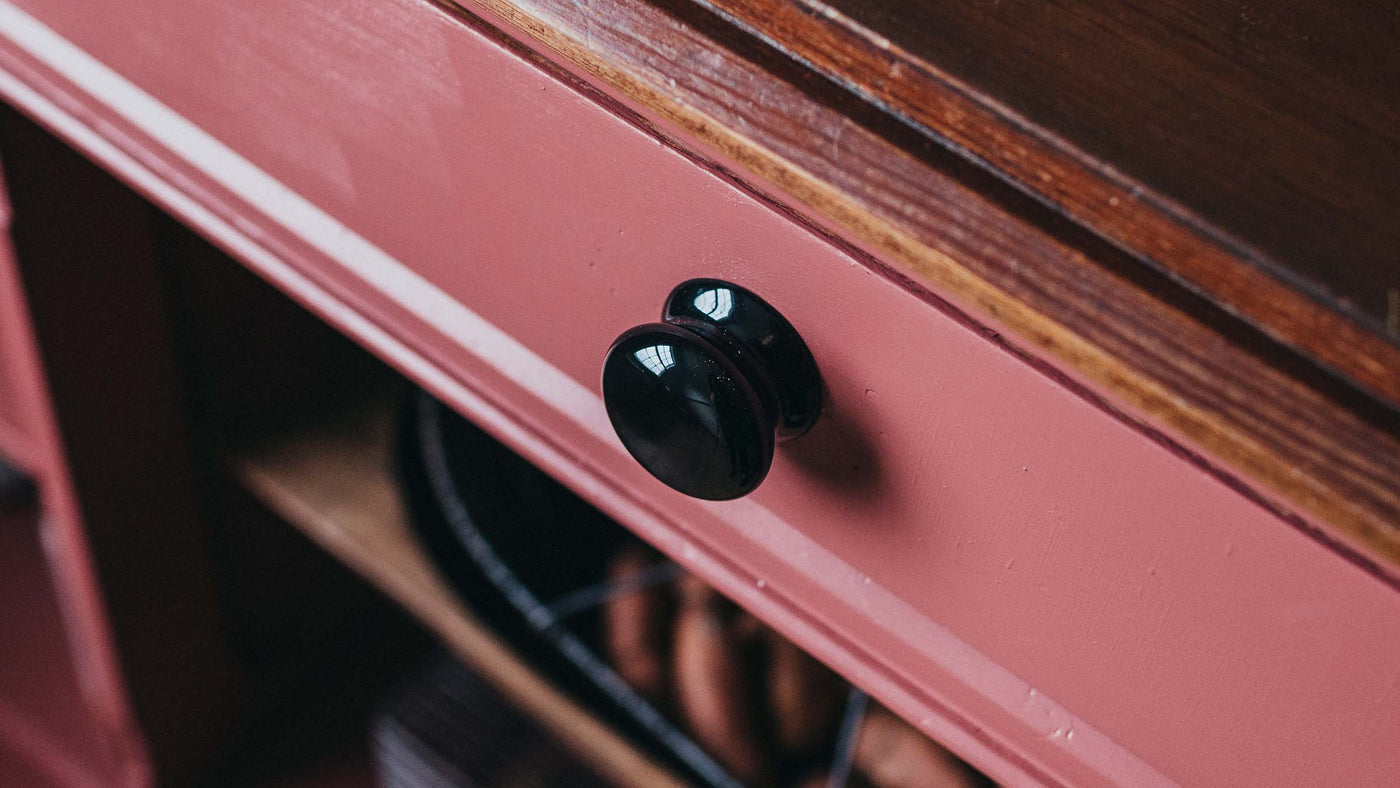 Ceramic Victorian style knob on pink dresser