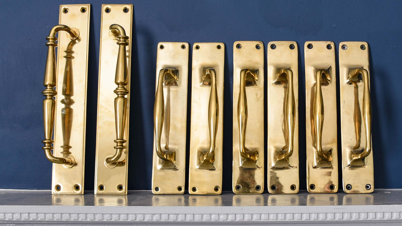 Antique Victorian Brass Pull Handles in a row on a mantlepiece from an Old British Bank