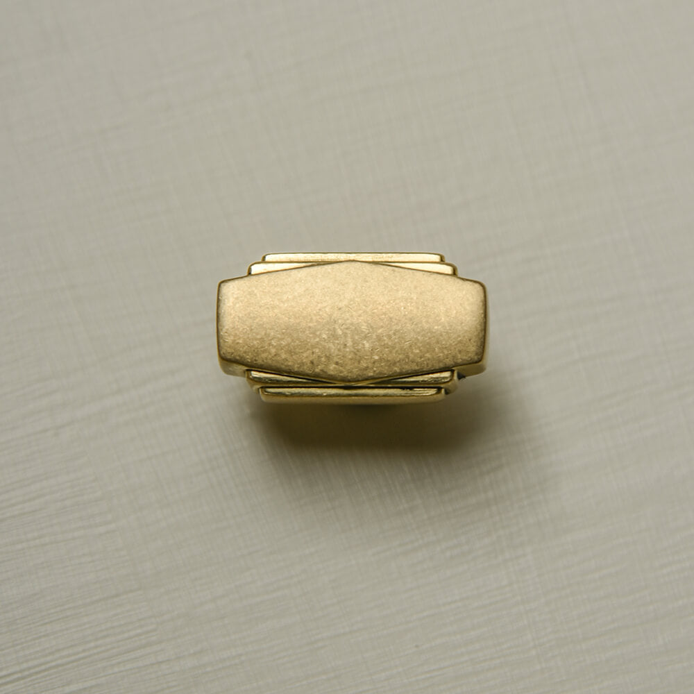 Aged Brass Art Deco Cabinet Knob in a rectangular  design with reeded deco style edges shown from the front face