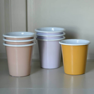 stacked enamel cups in pink, lilac and yellow