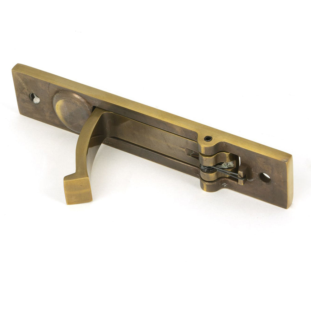 Reverse side of aged bronze pocket door handle showing the back mechanism