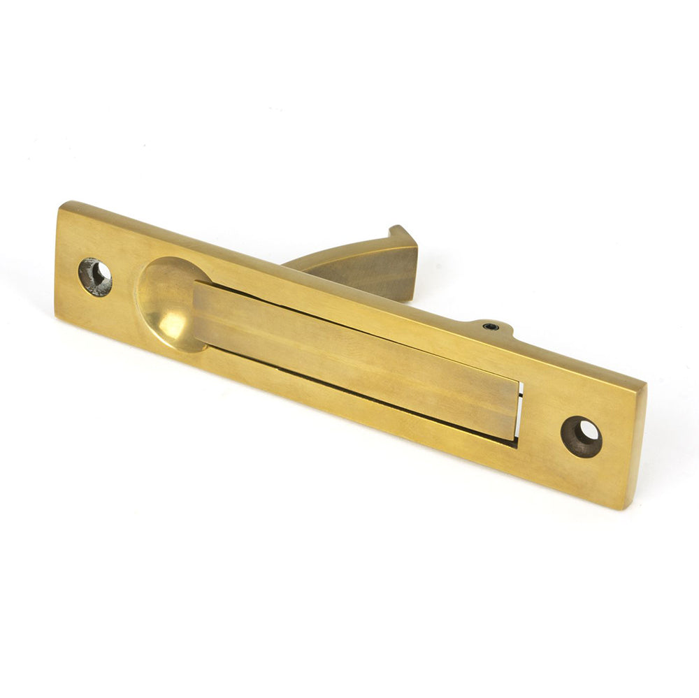 Aged brass sliding pull handle against white background