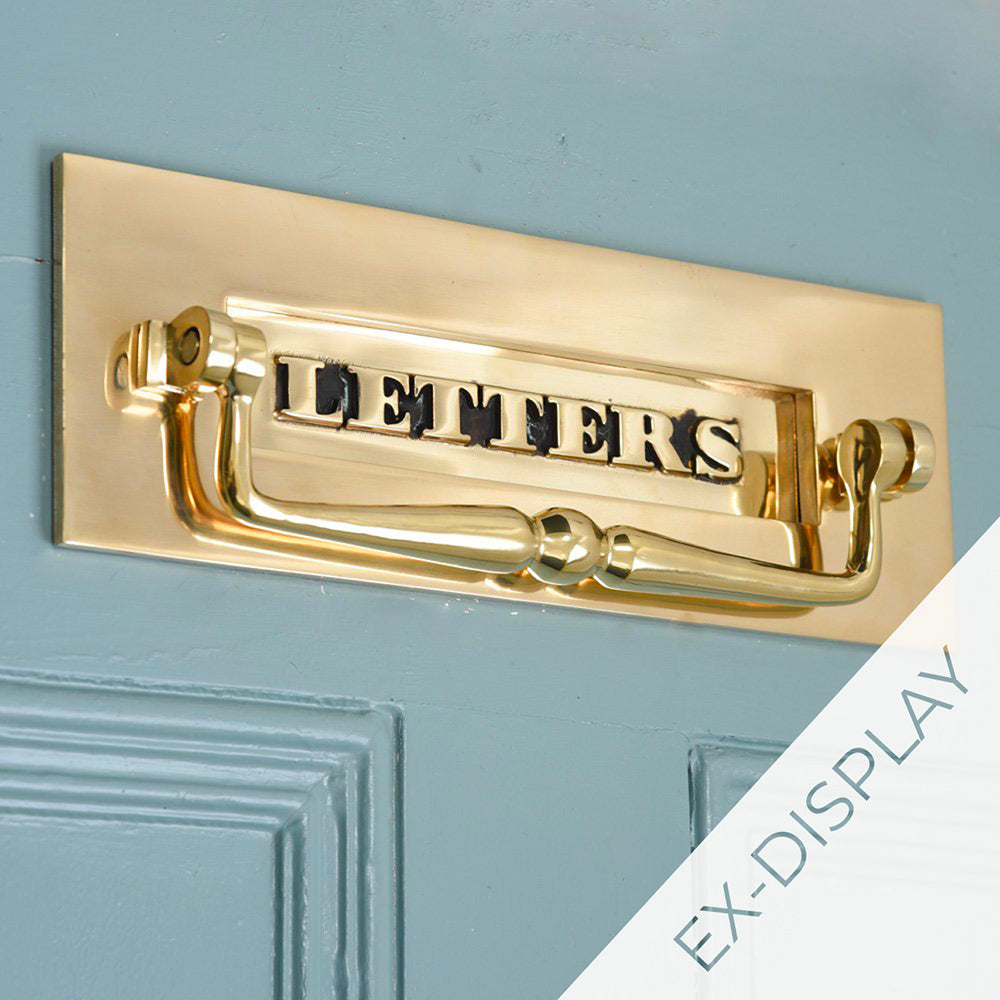 Polished antique brass classic letters letterplate with clapper on a blue door with a watermark and ex display text in the corner