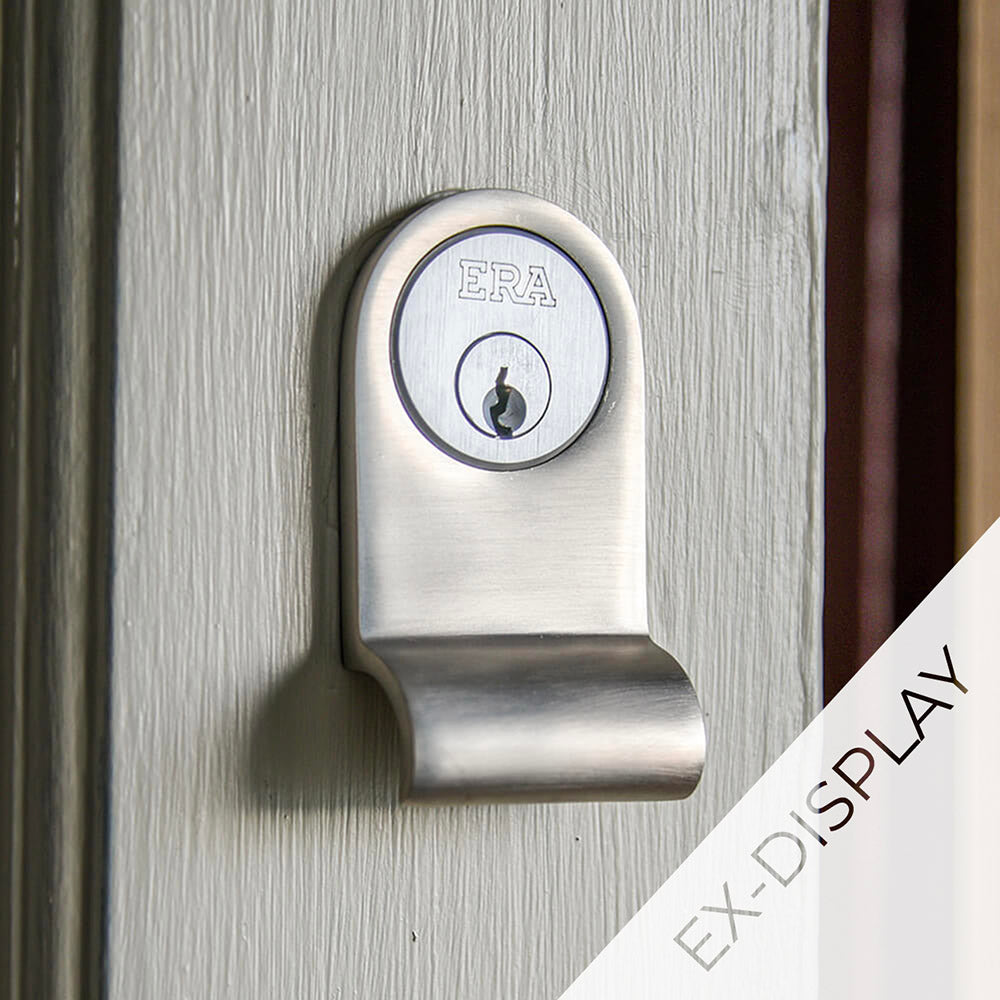 Satin nickel cylinder latch pull surrounding a yale lock on anoff-white door with a watermark and ex display text in the corner