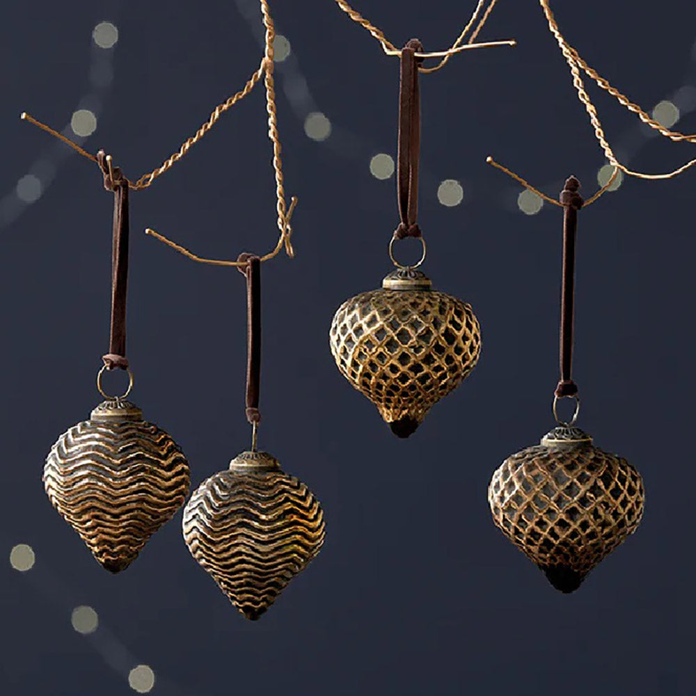 set of 4 black and gold glass teardrop baubles hanging from copper wire with cark velvet ribbon against a dark blue background