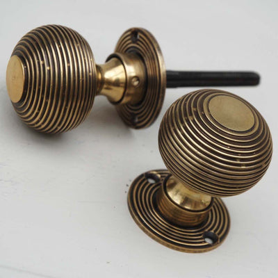 Pair of aged brass beehive door knobs