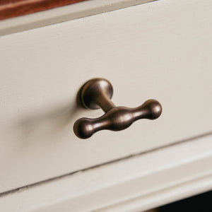 T Bar Anchor cabinet knob on kitchen drawer seen in distressed antique brass