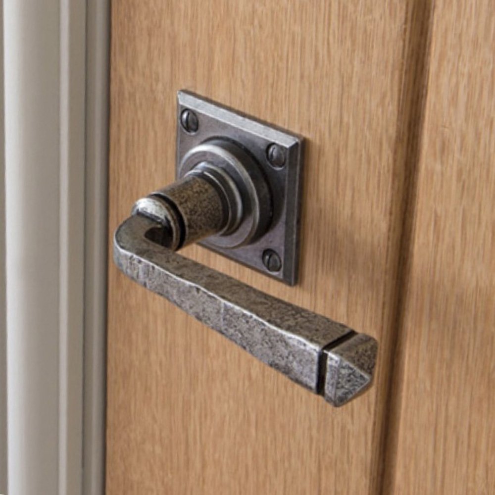 Avon lever handle in a pewter finish fitted in place to a door