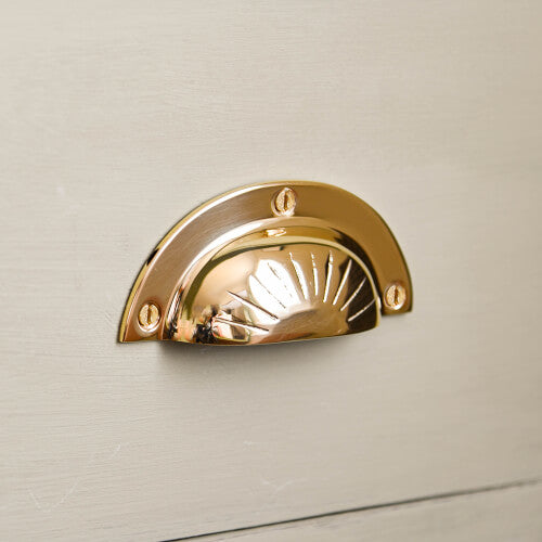 Brass curved drawer pull with reeded sunshine design