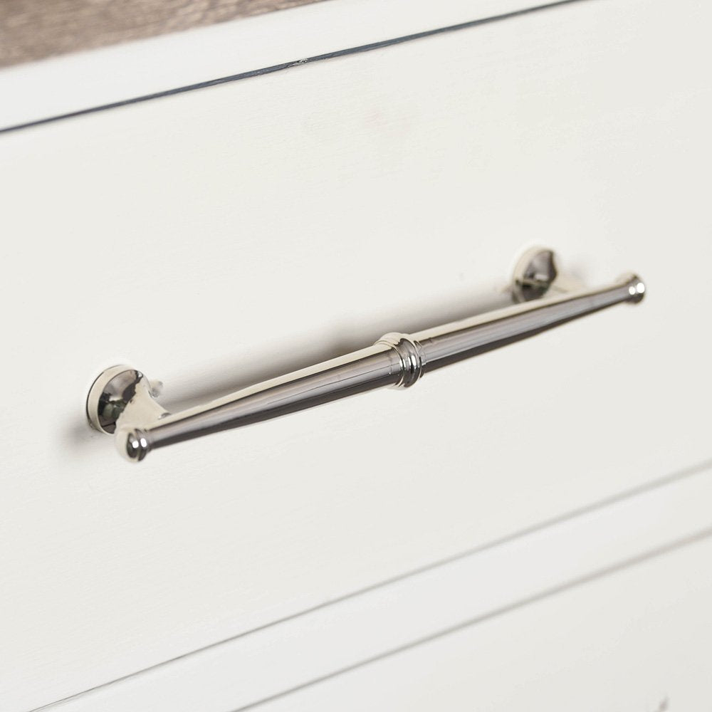 A regency pull handle in a polished nickel finish fitted to drawers