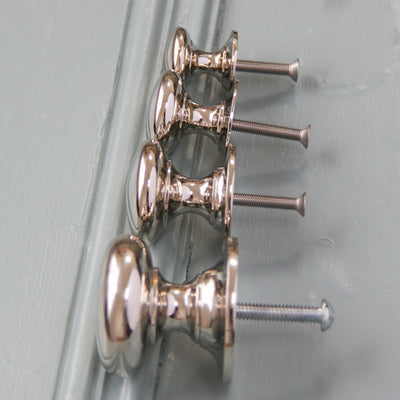 Row of nickel cabinet knobs with screws