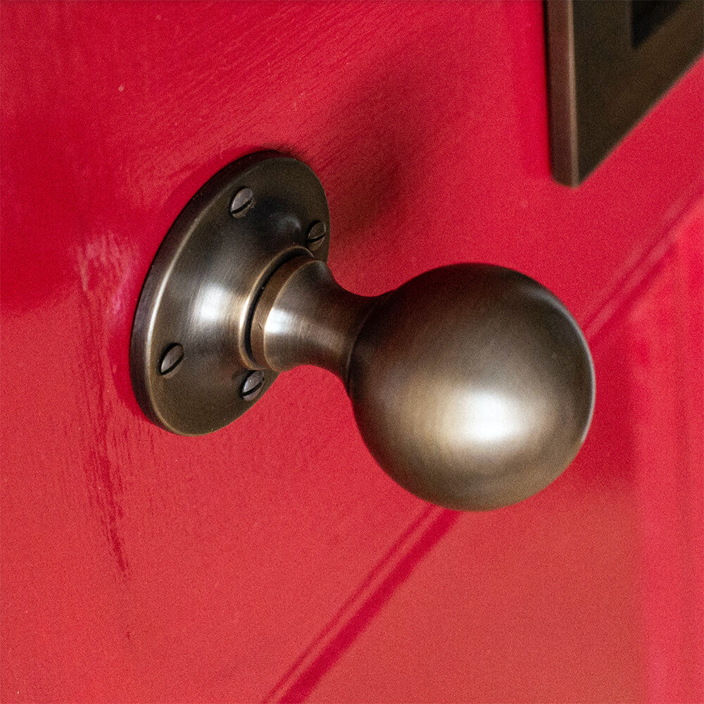 Red door featuring Light Antique Brass.