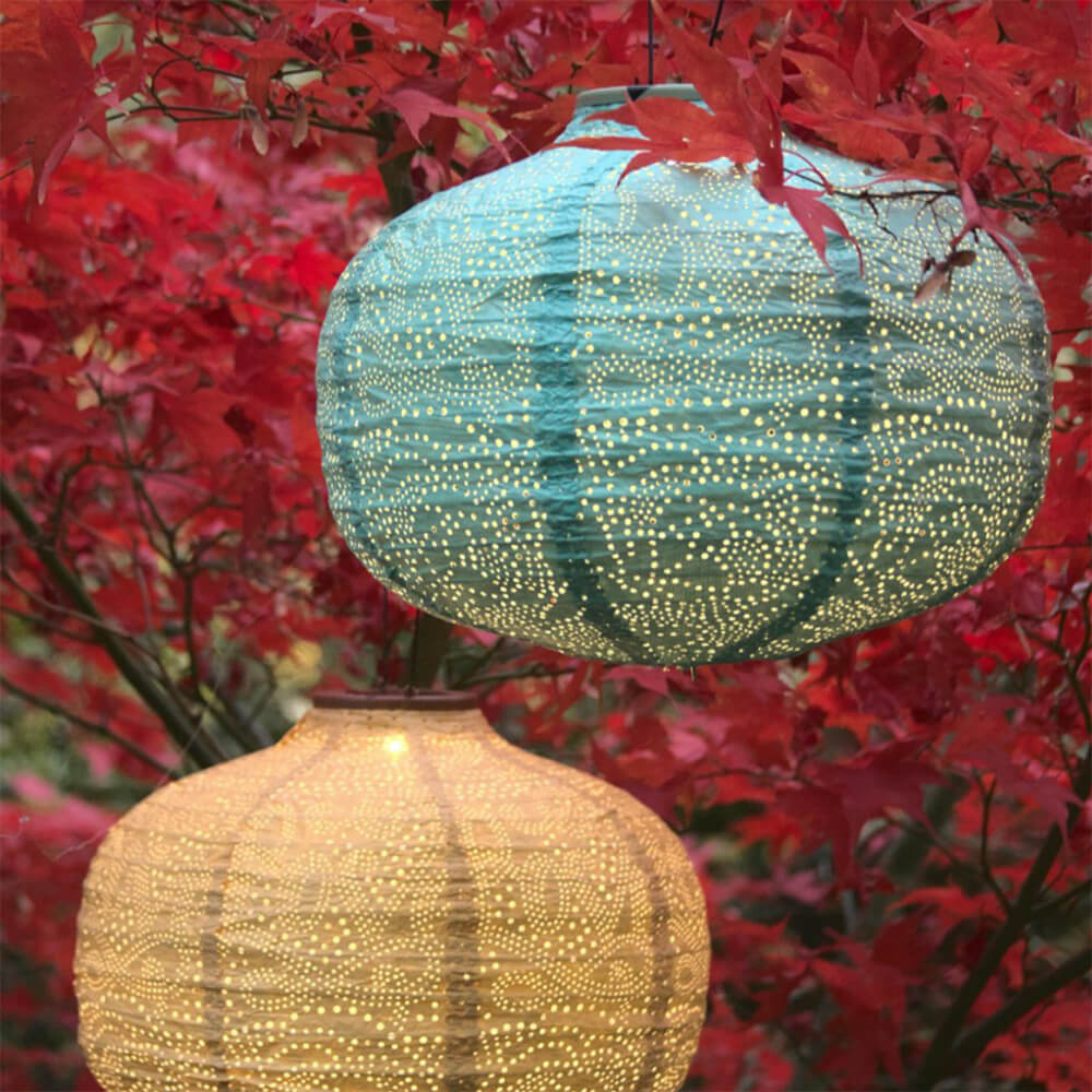 Solar Pumpkin shaped lantern hung in trees