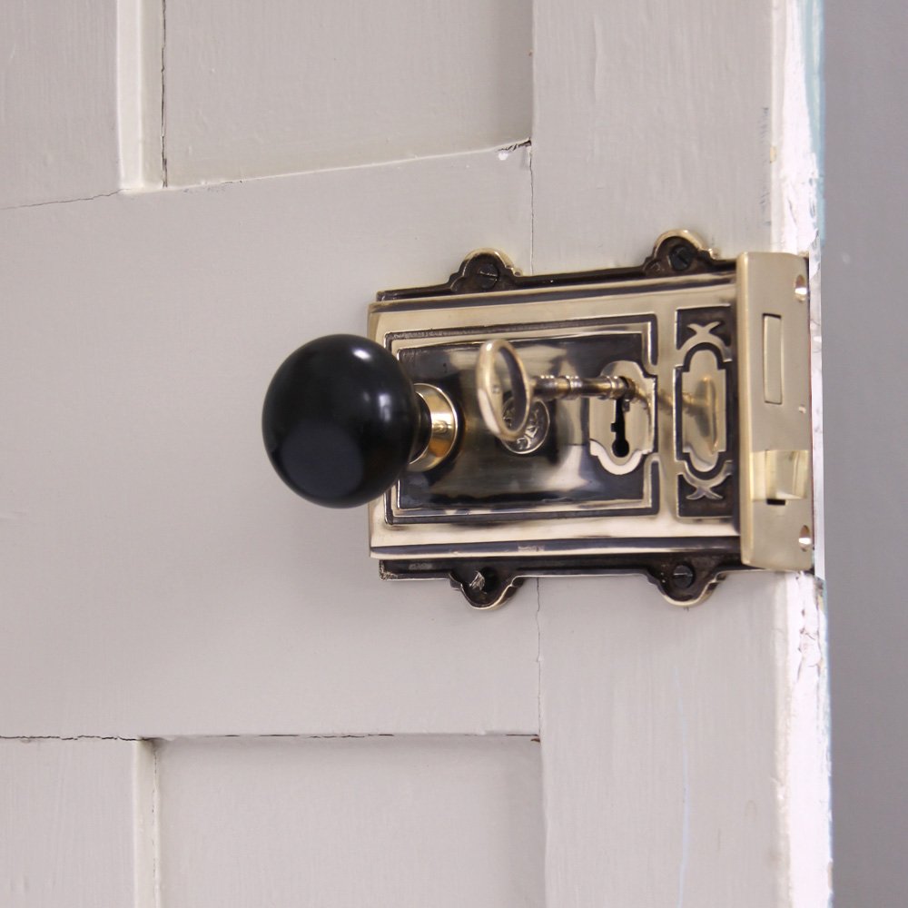 Solid ebony and brass bun door knob on brass rim lock