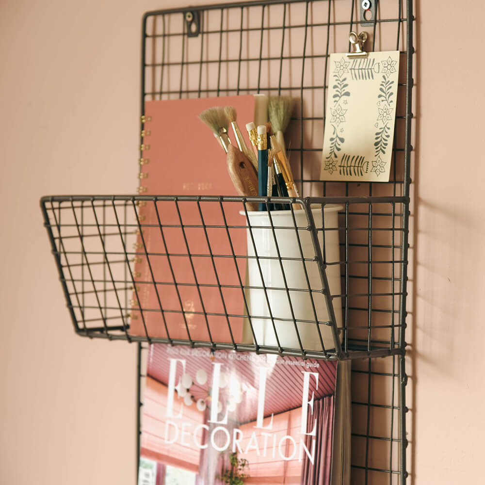 Detail of wire magazine rack holding stationery