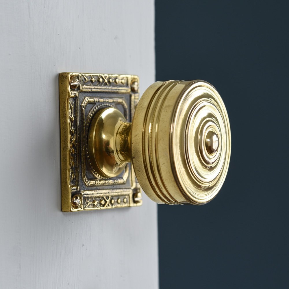 Reeded Brass Door Knobs on Ornate Square Backplate