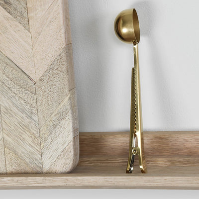 Close up of clip on brass coffee scoop