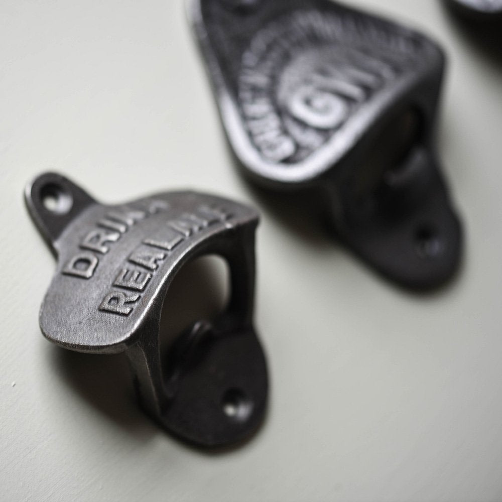 Detail of Cast Iron Wall Mounted Bottle Opener, with 'DRINK REAL ALE' Text