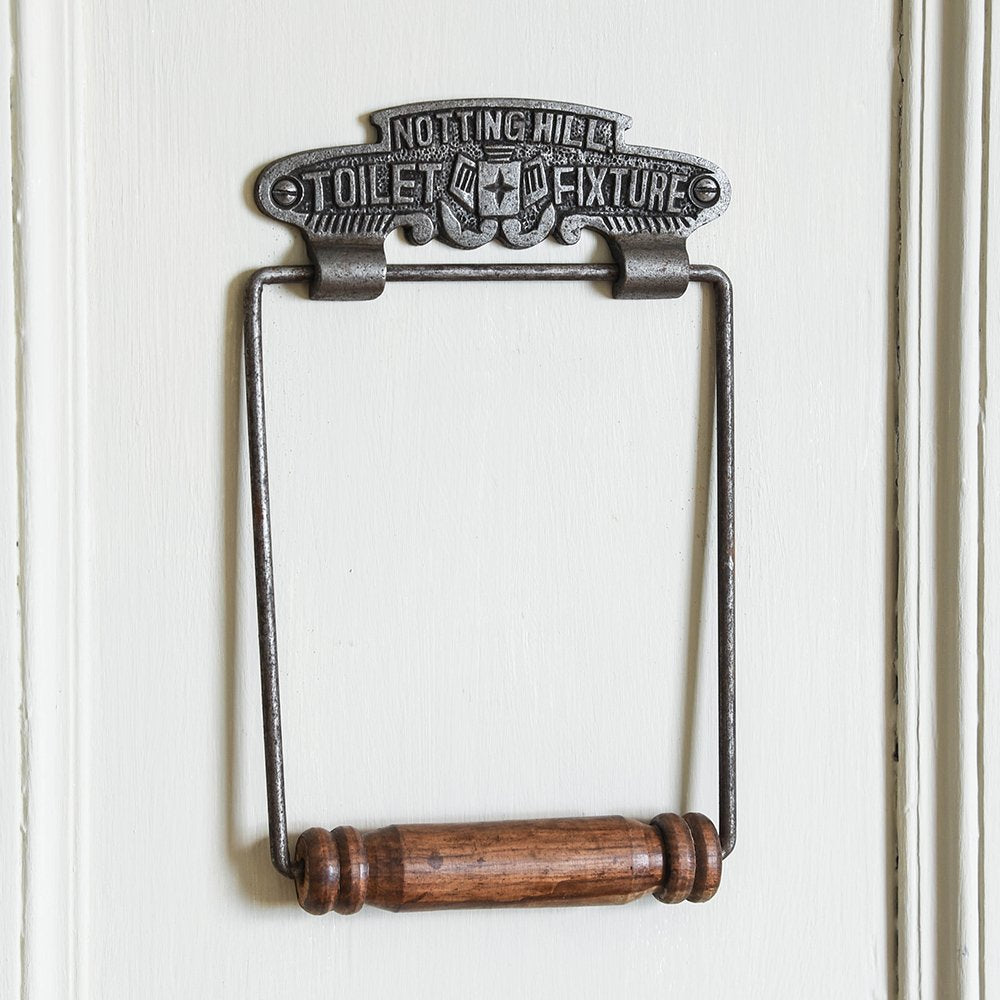 Ornate Cast Iron Toilet Roll Holder with 'NOTTING HILL TOILET FIXTURE' Text and Wooden Roller