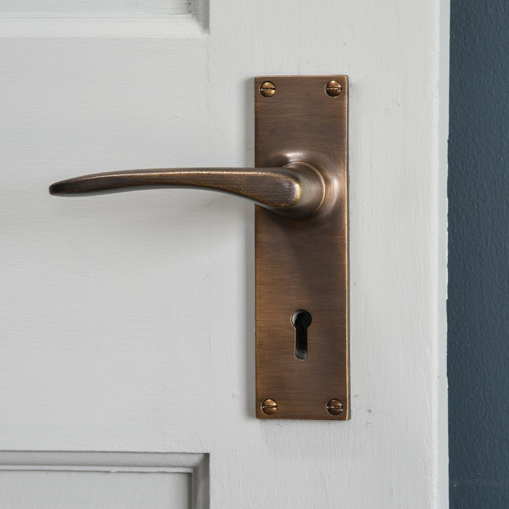 Oaken Lever Handles with Rectangular Backplate in Distressed Antique Brass