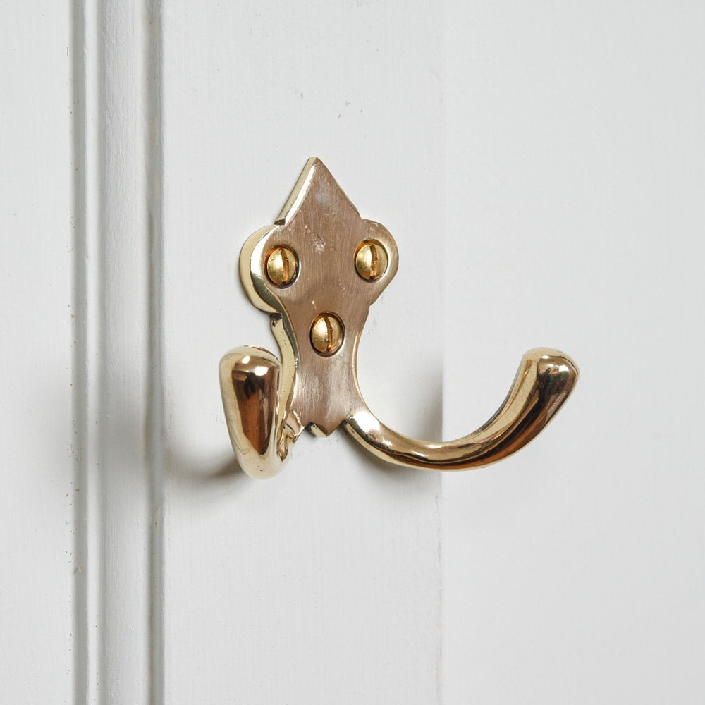 http://www.willowandstone.co.uk/cdn/shop/products/ornate-brass-double-wardrobe-hook.jpg?v=1643380630
