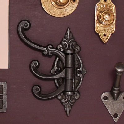 Ornate Triple Hinged Hook in Cast Iron Amongst Other Ironmongery Pieces