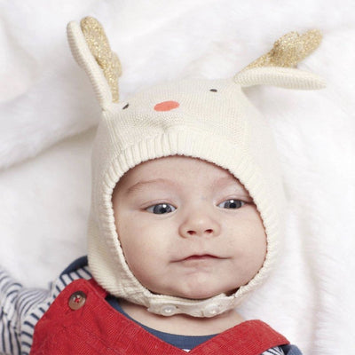 Knitted reindeer baby bonnet modelled on baby