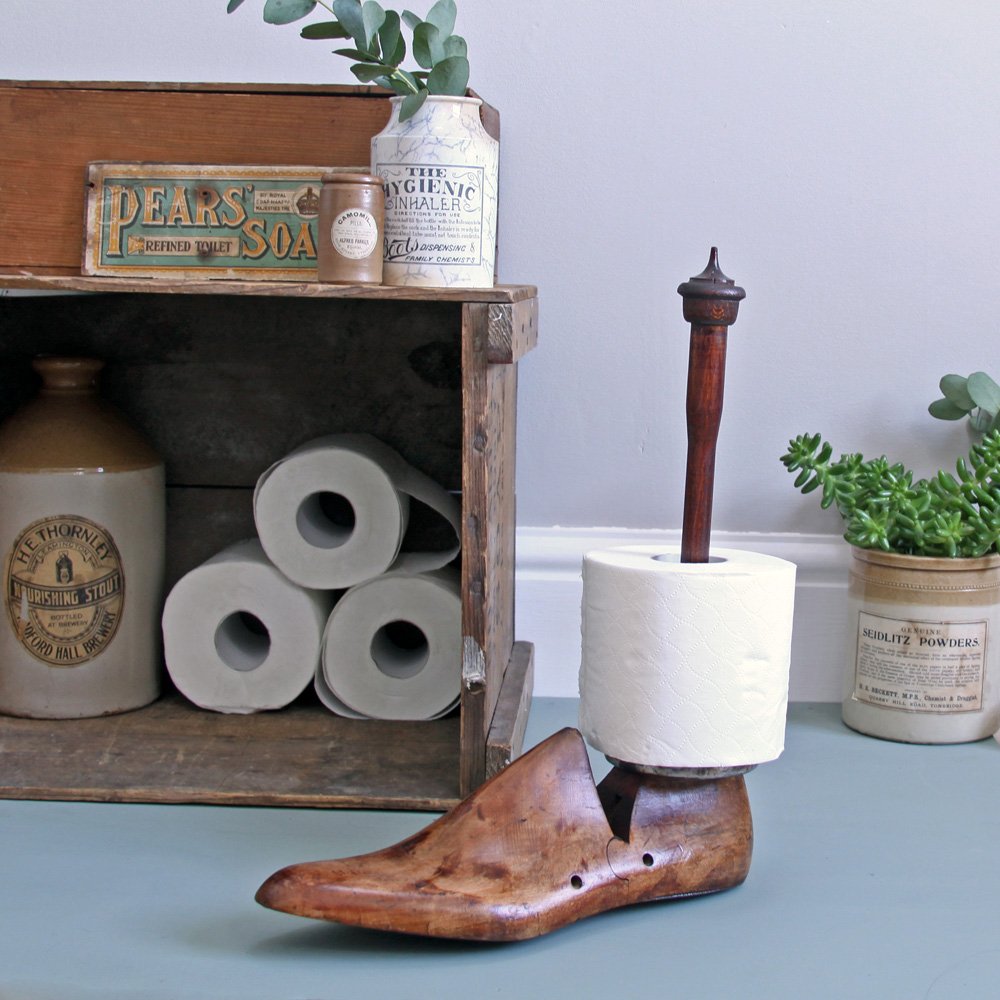 Wooden shoe last toilet roll holder in situ with one toilet roll