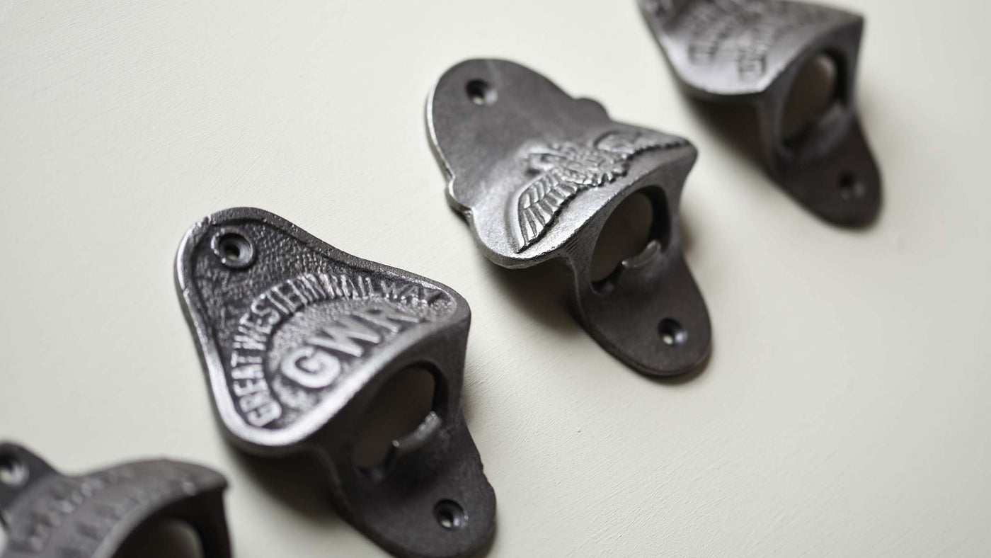 Cast Iron Bottle Openers in a row