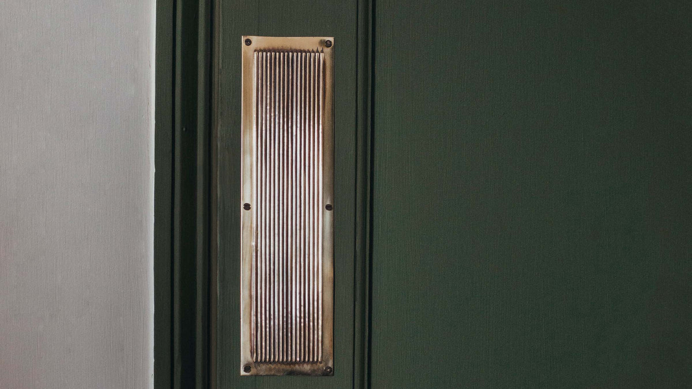 Brass Reeded Beehive Fingerplate on green Victorian door.