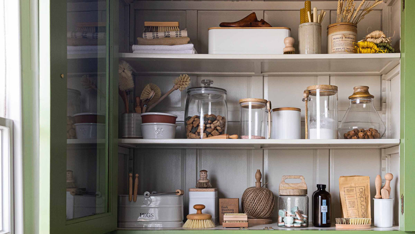 Kitchen Storage Jars and baskets on shelf in pantry cupboard