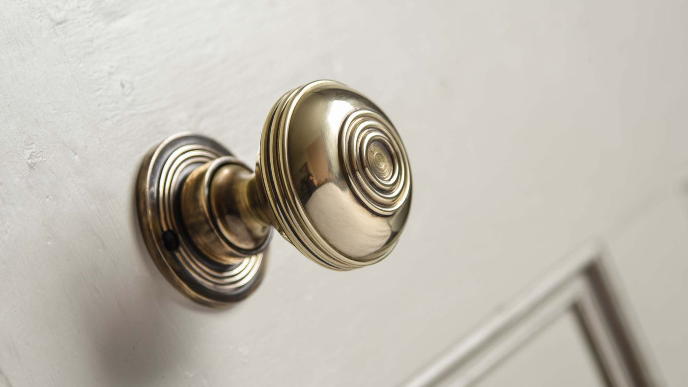 Large Brass Door Knobs with a Polished Antiqued Brass finish on painted door