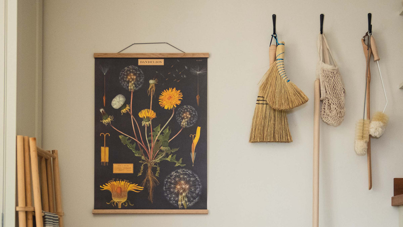 Dandelion Poster Wrap sheet seen hung from an oak picture hanger on wall of laundry room