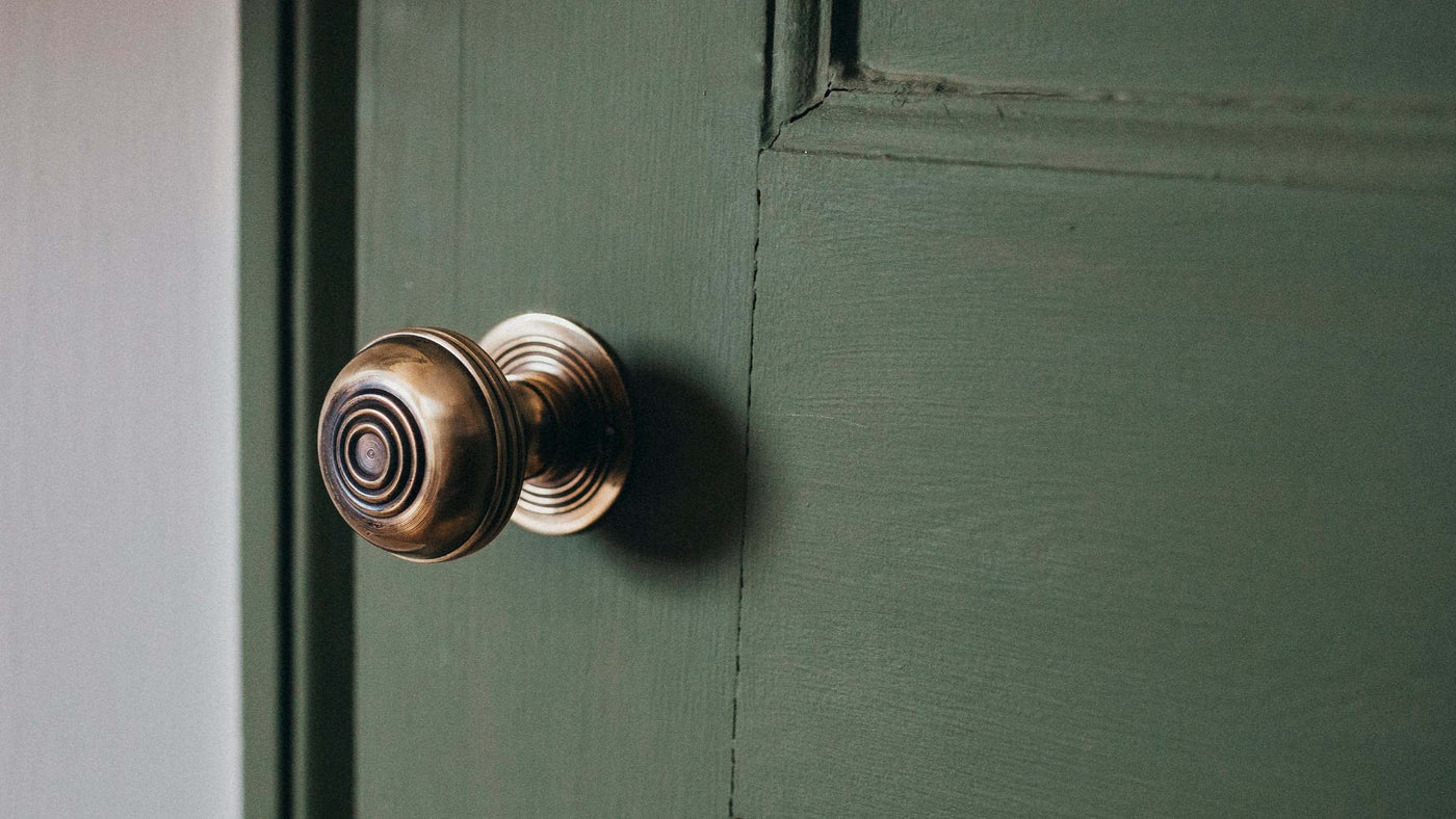 Brass Door Knobs on Green Door