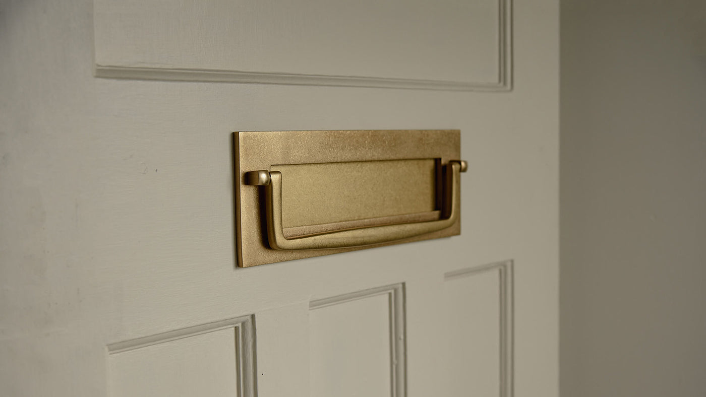 Aged Brass Marlborough Letterplate with Clapper on pale front door