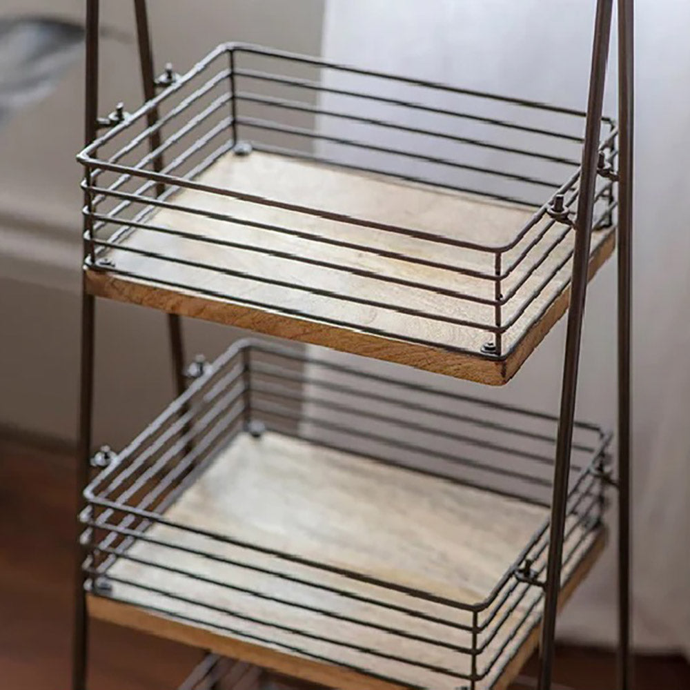 Close up of bathroom caddy featuring the mango wood shelf bases and wire frames