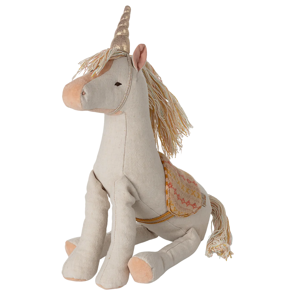 Stuffed unicorn toy with decorative elements on a white background