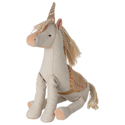 Stuffed unicorn toy with decorative elements on a white background
