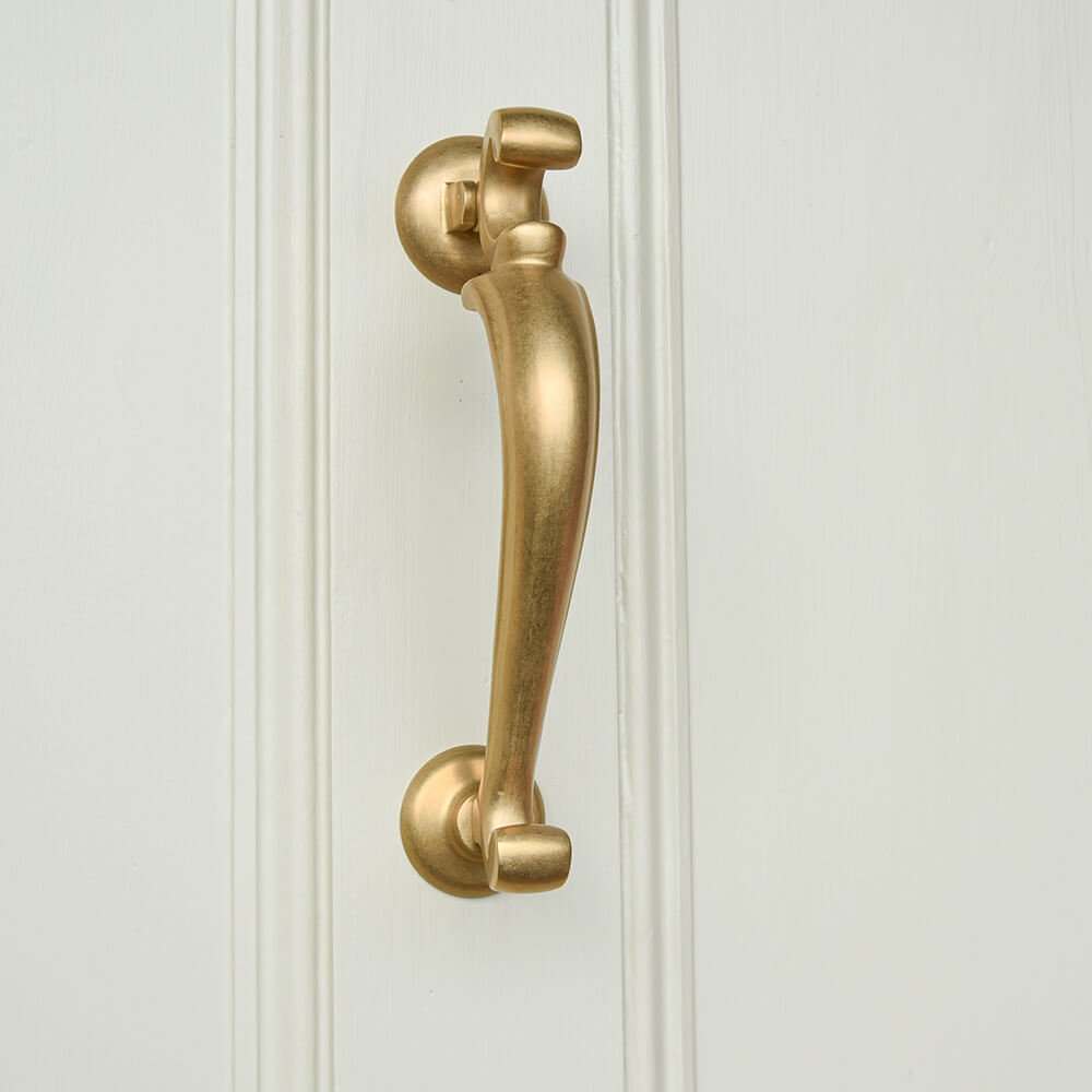Brass door knocker on a white panelled door