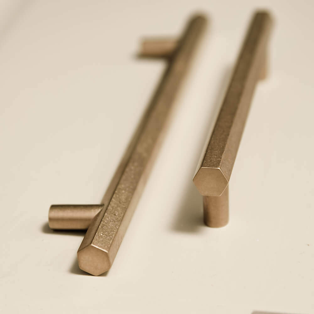 Hexagonal shaped pull handles in two sizes seen next to eachother