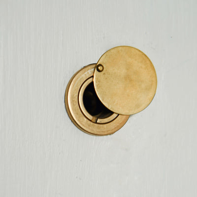 aged brass door viewer mounted on door