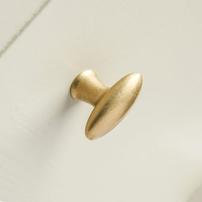Zepplin shaped elongated oval aged brass cupboard knob