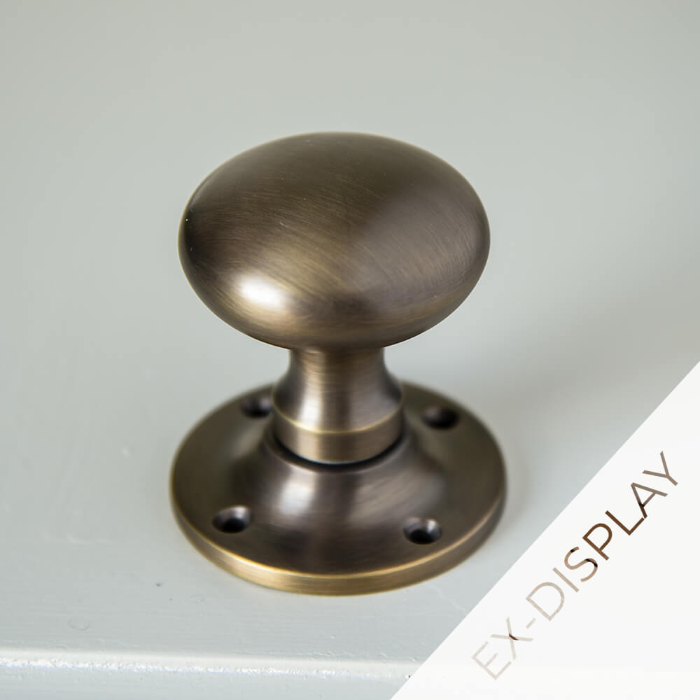 Cushion style bun door knob in a brown brass lightly brushed finish