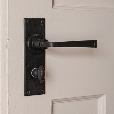 Black lever handles on door with thumbturn lock