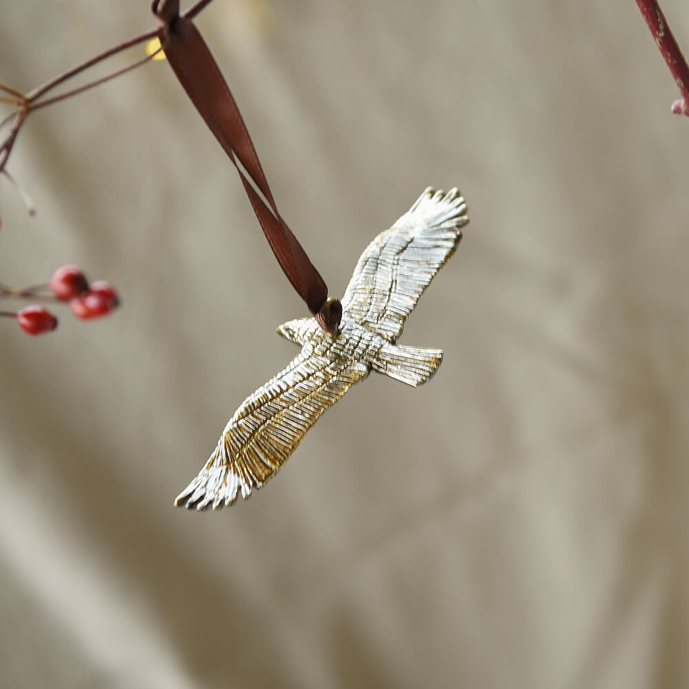 Bird decoration with hanging from a branch on a neutral background