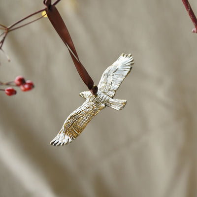 Bird decoration with hanging from a branch on a neutral background