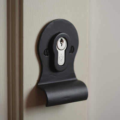 Matt Black Cylinder latch cover with a euro lock on a door