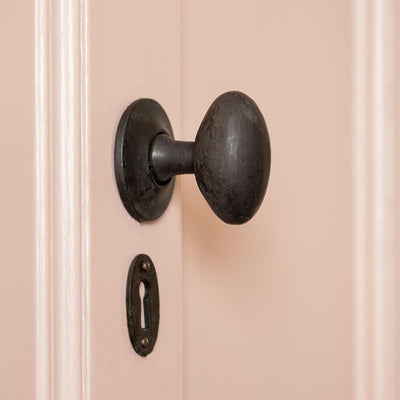 Black Oval Door Knobs on pink door