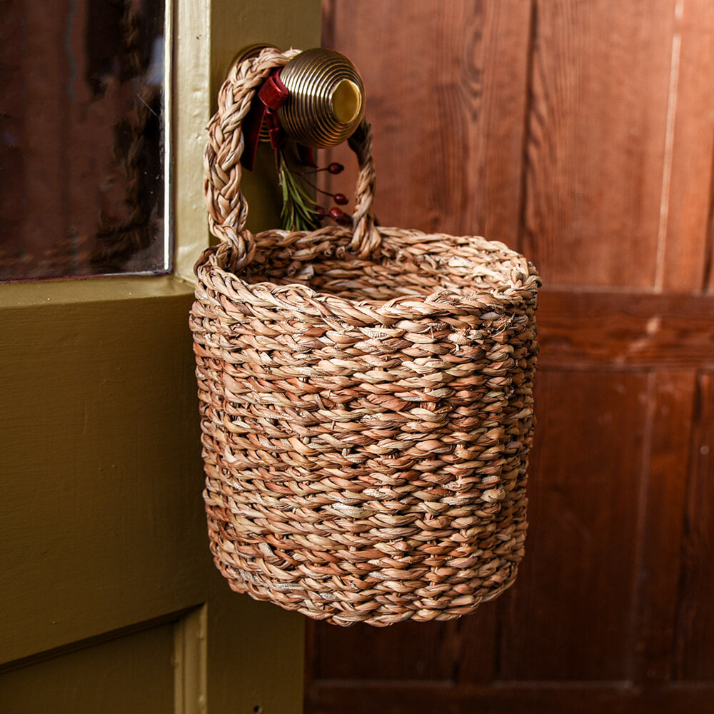 Basket on brass door handle with mustard yellow door