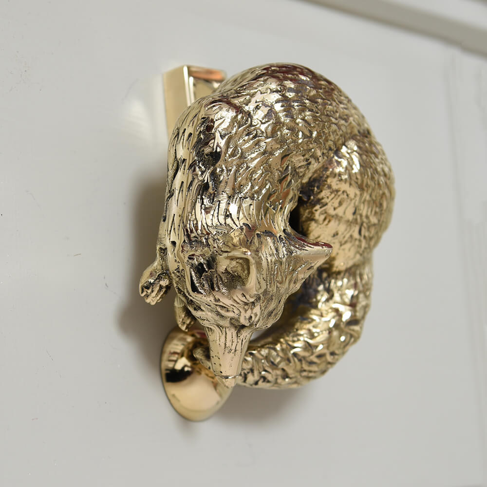 Brass fox door knocker with strike plate showing beautiful face and curled tail from the side